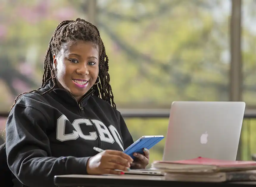 CCBC student studies in th elobby on her laptop