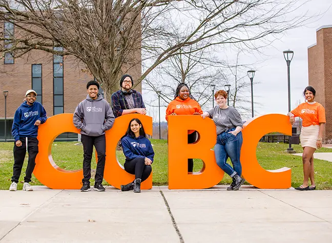 Group of honors students posing for a photo next to large CCBC letters